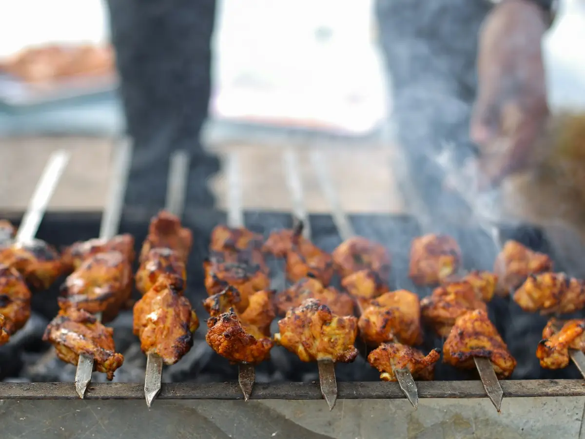 Chicken boti skewers over live charcoal